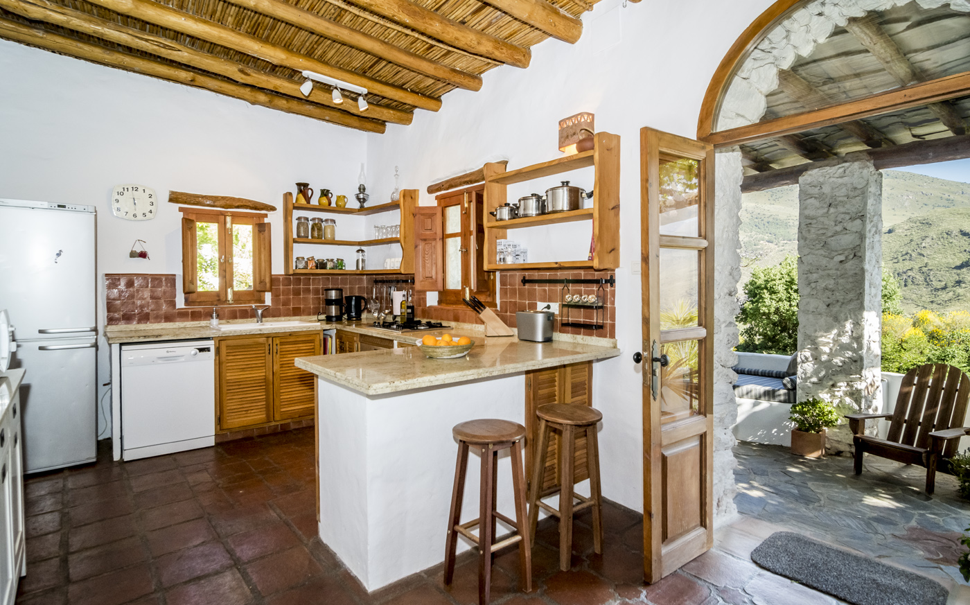 Country kitchen opening to terraces